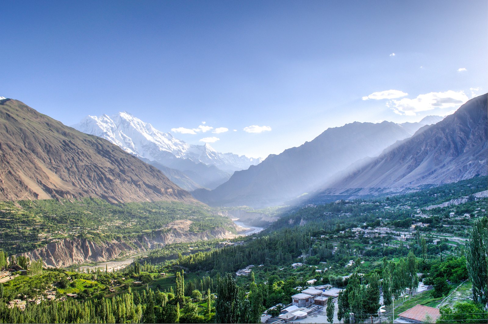 Panoramic view of Hunza valley with snow-capped peaks at sunrise