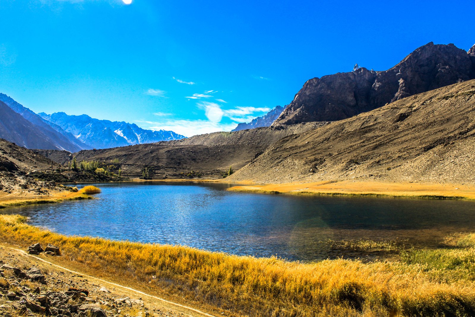 A turquoise glacial lake in Hunza valley surrounded by mountains