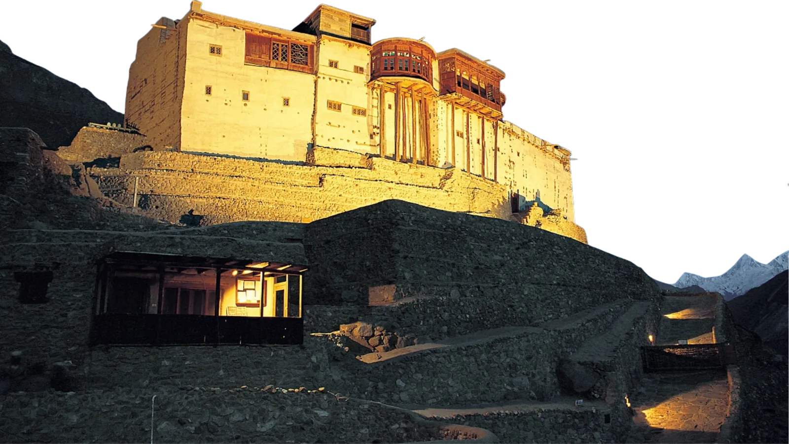 Baltit Fort lit up at night on the hillside above Karimabad